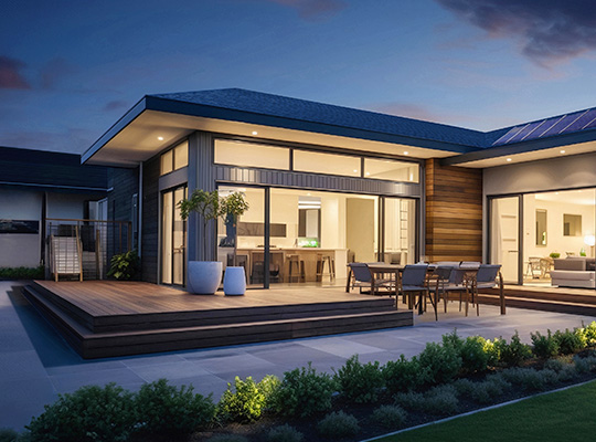 Modern home with lights on at dusk