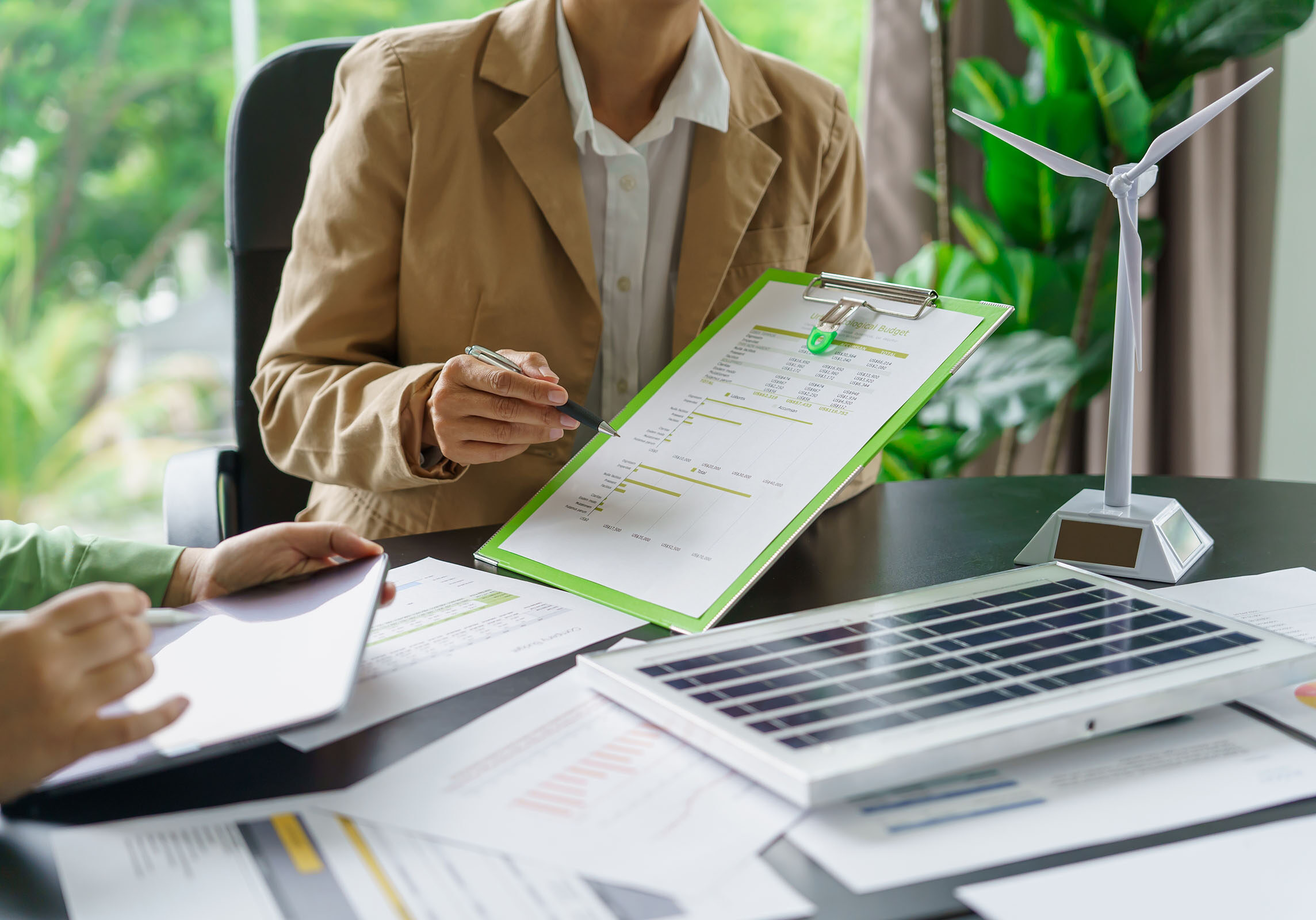 Solar panels green energy Business people working in green eco friendly office business meeting creative ideas for business eco friendly professional teaching corporate people sustainable electricity